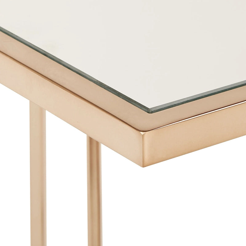 Mesa de centro con acabado dorado champán y tapa de espejo
