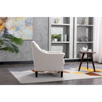 Sillón tapizado en lino con tachuelas y patas de madera maciza