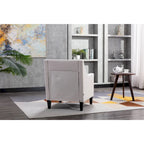 Sillón tapizado en lino con tachuelas y patas de madera maciza
